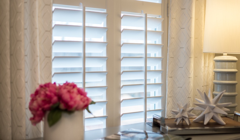 Plantation shutters by flowers in San Antonio